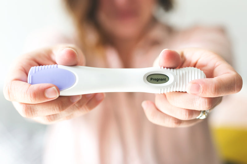 Positive pregnancy test representing maternal health, fertility, and Nutreska Clinical pregnancy-safe supplement guidance. Is Melatonin safe to take during pregnancy? Can I take melatonin while pregnant?